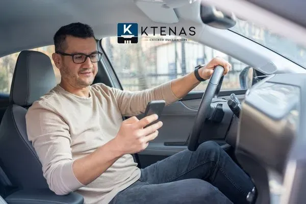 man driving and texting