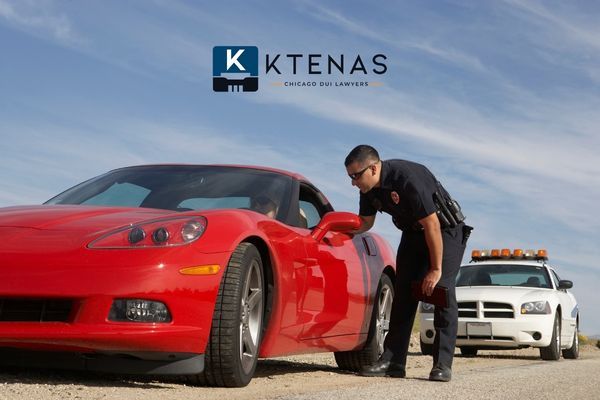 A police officer leaning into the window of a red sports car during a traffic stop